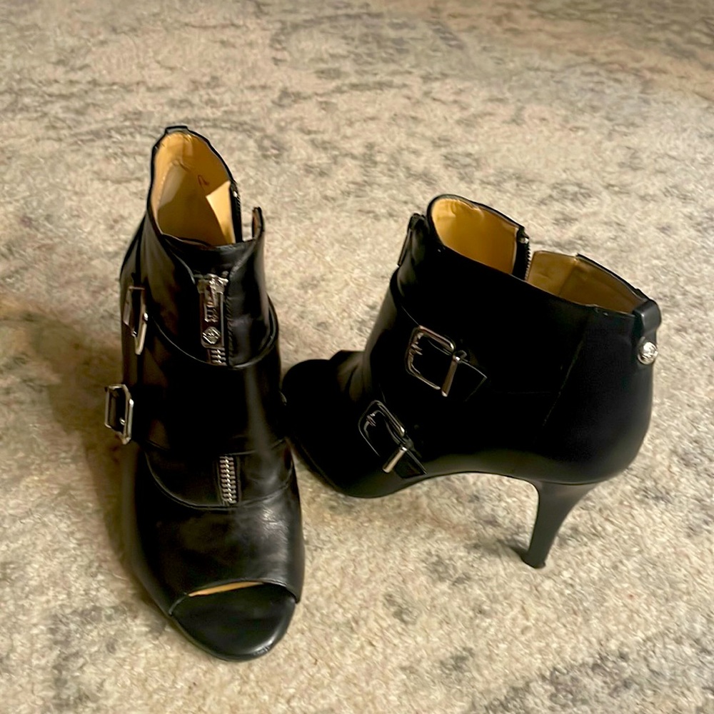 Black toe out anklet boots with silver buckles and zipper.